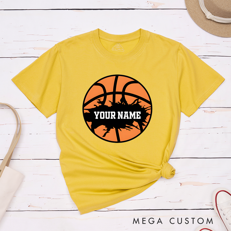 Personalized Basketball T-Shirt Design Featuring Bold Orange Basketball Graphic with Splatter Effect and Customizable Name