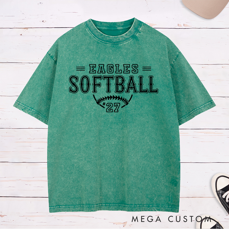 Personalized Softball Washed T-Shirt Featuring a Customizable Team Name Player Number Vintage-Inspired Typography and a Softball Stitch Graphic