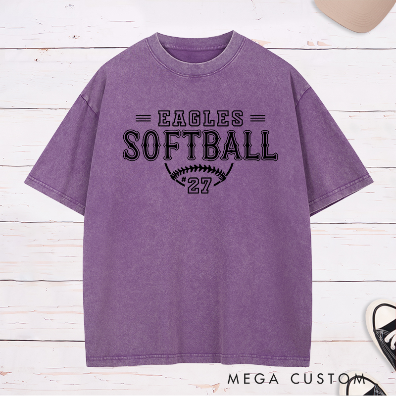 Personalized Softball Washed T-Shirt Featuring a Customizable Team Name Player Number Vintage-Inspired Typography and a Softball Stitch Graphic