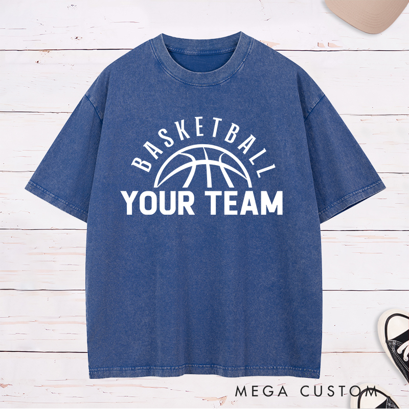Personalized Washed T-Shirt Design Featuring a Clean Basketball Graphic with a Customizable Team Name Below an Arched Basketball Text