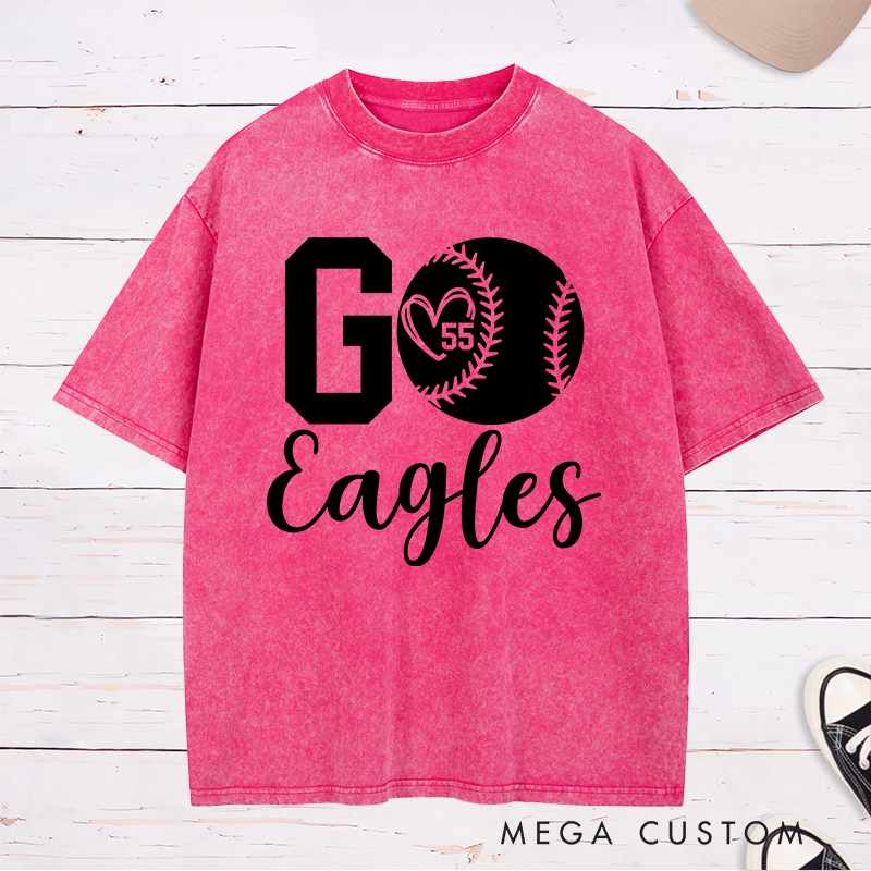 Personalized Softball Spirit Washed T-Shirt Design Featuring Bold "Go" Text Team Name in Elegant Script Heart-Shaped Player Number Inside a Softball Graphic Perfect for Fans and Players