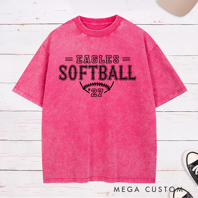 Personalized Softball Washed T-Shirt Featuring a Customizable Team Name Player Number Vintage-Inspired Typography and a Softball Stitch Graphic