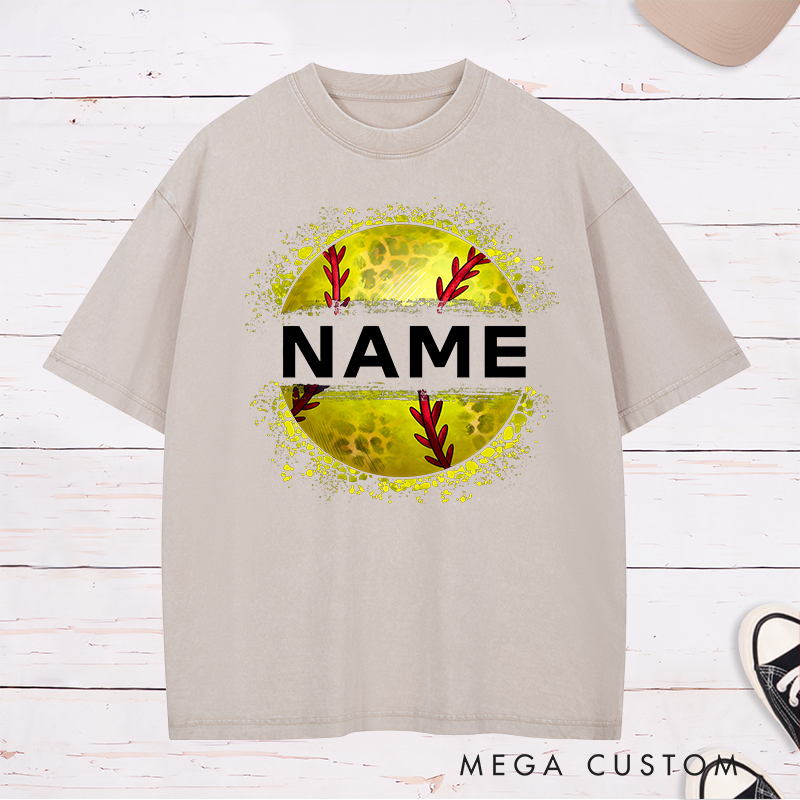Personalized Softball Washed T-Shirt Design Featuring Custom Name Displayed Boldly Across a Distressed Softball Graphic with Textured Details