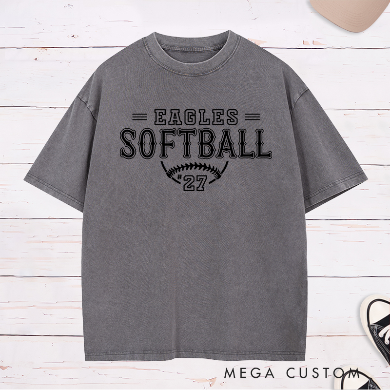 Personalized Softball Washed T-Shirt Featuring a Customizable Team Name Player Number Vintage-Inspired Typography and a Softball Stitch Graphic