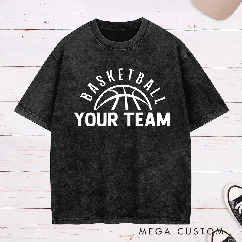 Personalized Washed T-Shirt Design Featuring a Clean Basketball Graphic with a Customizable Team Name Below an Arched Basketball Text