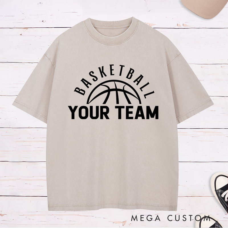 Personalized Washed T-Shirt Design Featuring a Clean Basketball Graphic with a Customizable Team Name Below an Arched Basketball Text