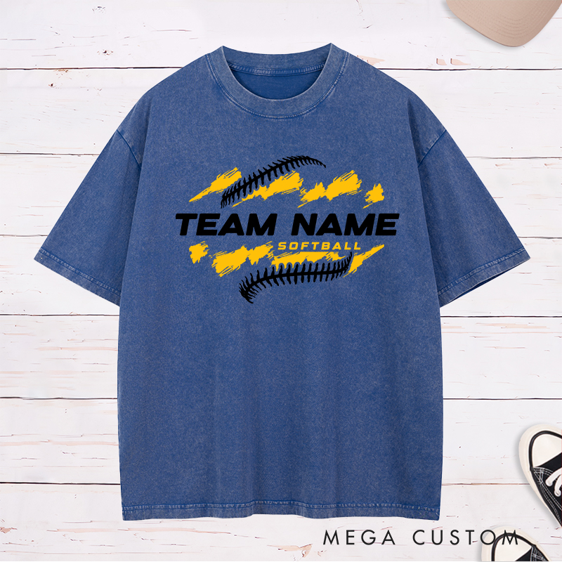 Personalized Softball Team Washed T-Shirt Design Featuring Customizable Team Name Bold Text Dynamic Brushstroke Elements and Softball Stitch Graphics