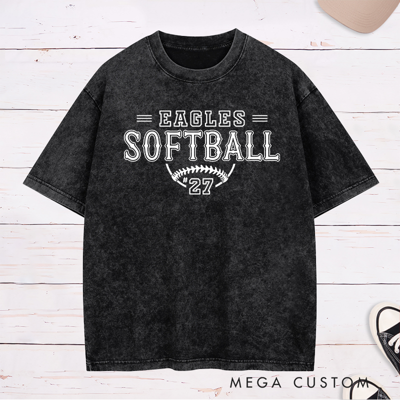 Personalized Softball Washed T-Shirt Featuring a Customizable Team Name Player Number Vintage-Inspired Typography and a Softball Stitch Graphic