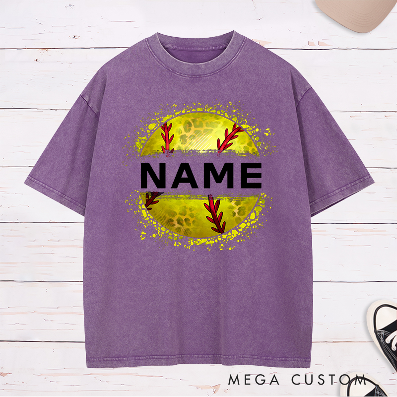 Personalized Softball Washed T-Shirt Design Featuring Custom Name Displayed Boldly Across a Distressed Softball Graphic with Textured Details