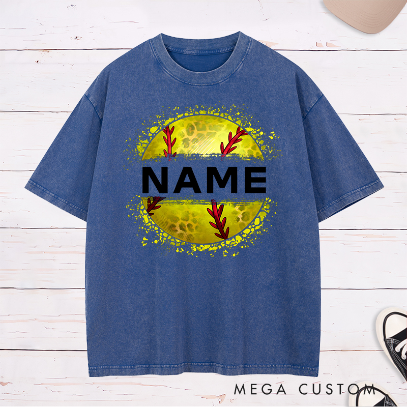Personalized Softball Washed T-Shirt Design Featuring Custom Name Displayed Boldly Across a Distressed Softball Graphic with Textured Details