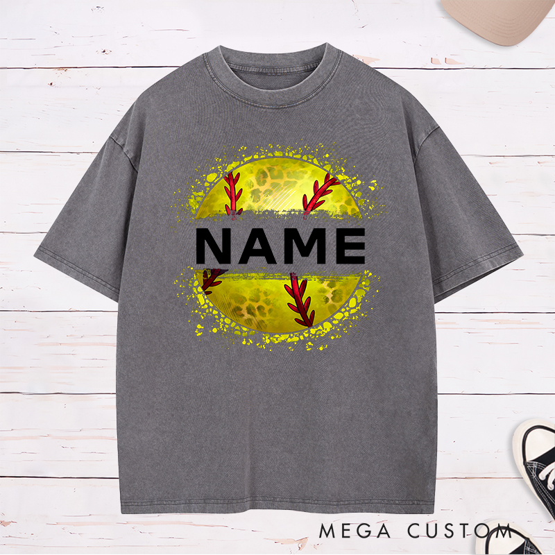 Personalized Softball Washed T-Shirt Design Featuring Custom Name Displayed Boldly Across a Distressed Softball Graphic with Textured Details