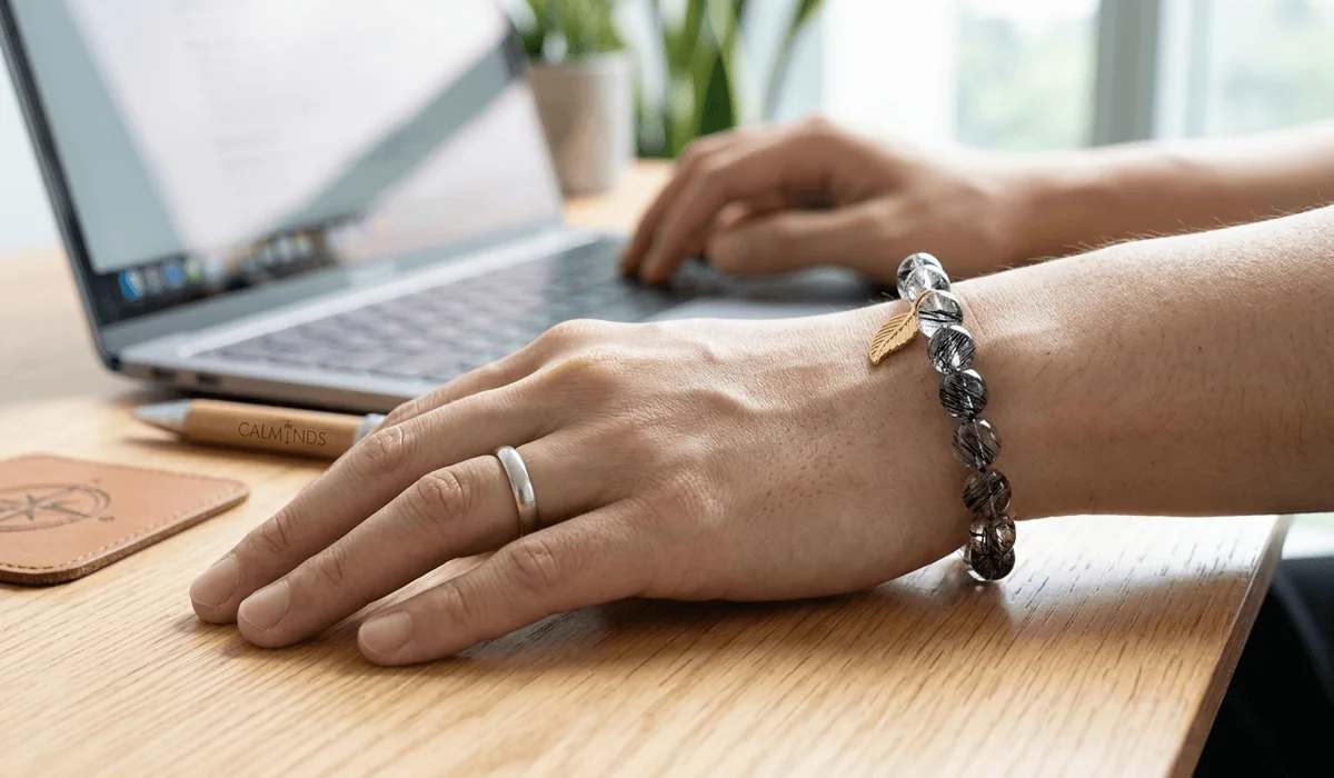 A person wearing a Black Rutilated Quartz bracelet on the right hand to enhance leadership and career manifestation.