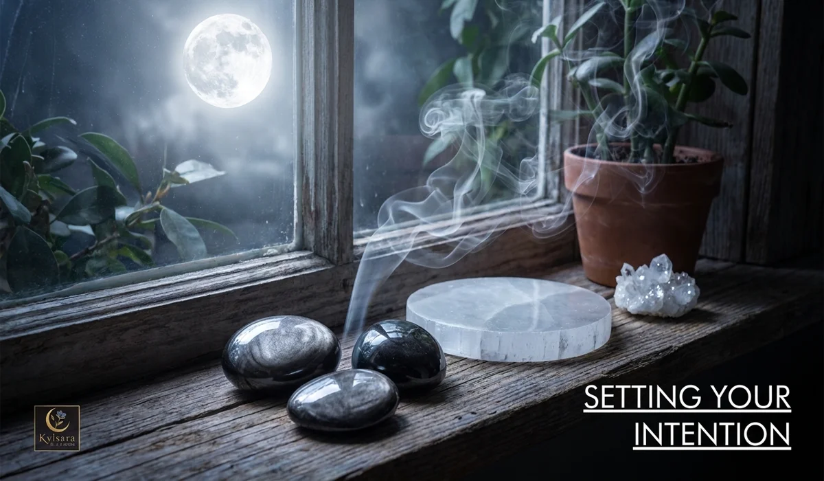 Cleansing Silver Sheen Obsidian stones with sage smoke and charging them under moonlight.