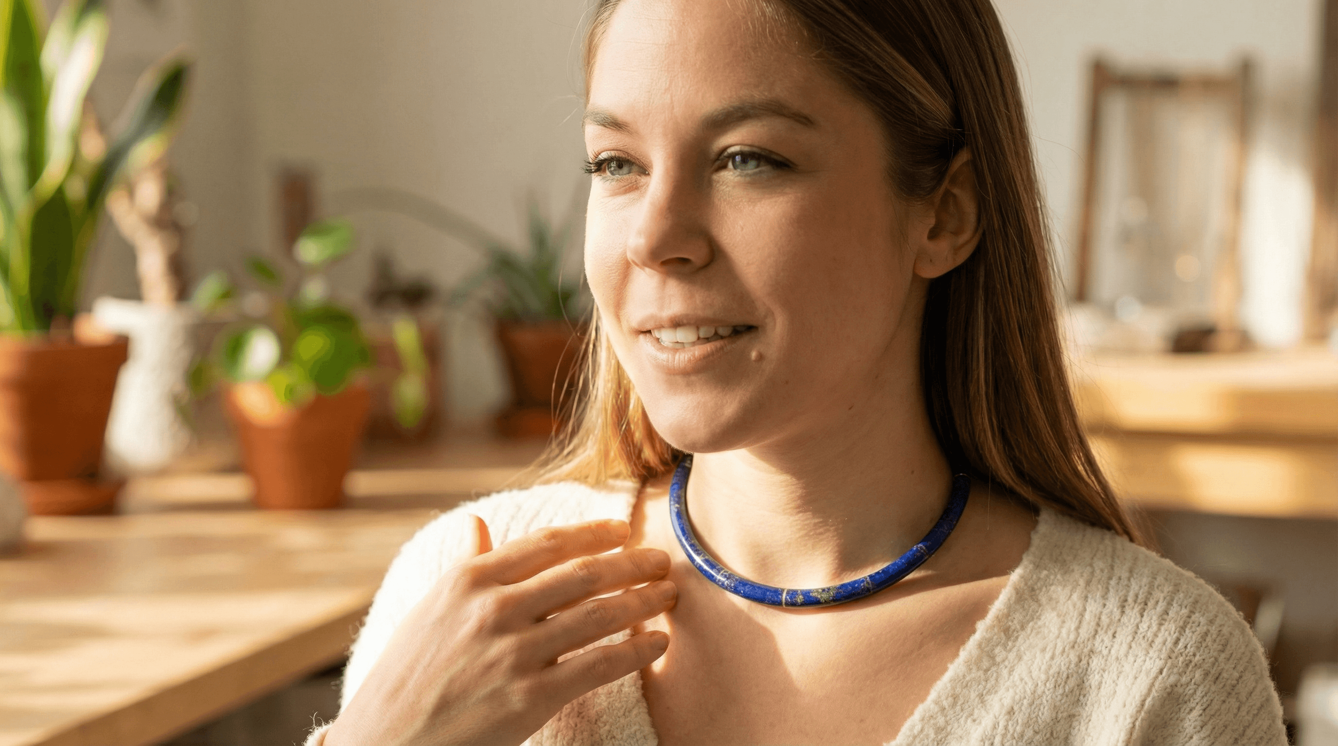 A woman wearing a Lapis Lazuli pendant necklace positioned near the throat to enhance communication and truth.