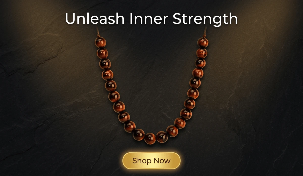Red Tiger's Eye 'The Fiery Guardian' beaded necklace on dark stone background with Shop Now button.
