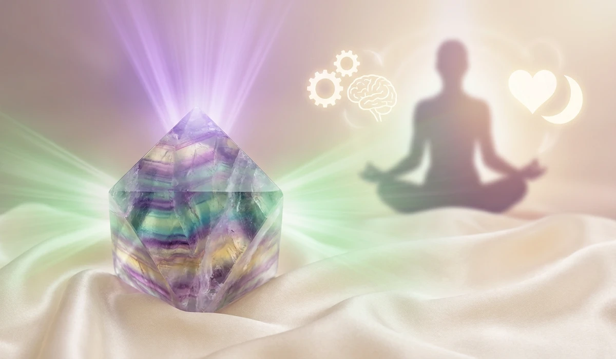 Rainbow Fluorite crystal on a silk cloth with ethereal light symbolizing chakra alignment and spiritual intuition.