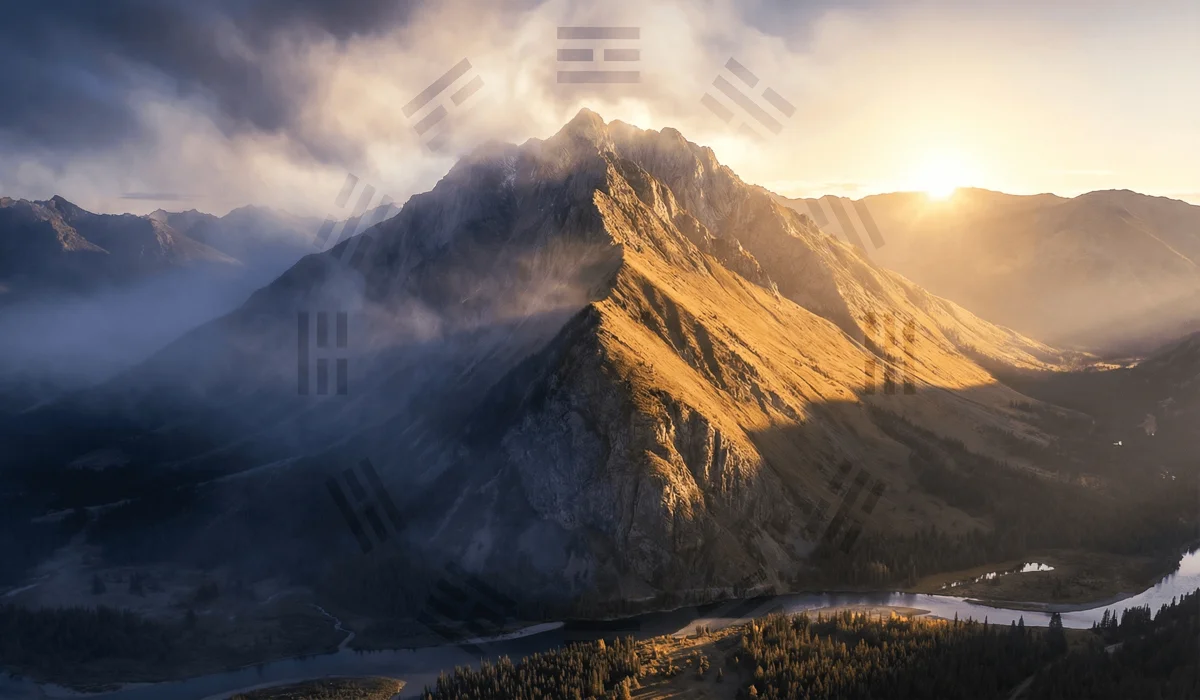 Cinematic landscape of a mountain showing the sunny side (Yang) and shaded side (Yin) representing the ancient origins of the Taiji symbol.