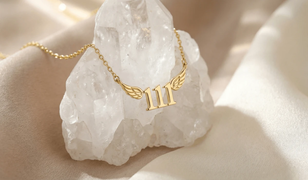 A minimalist gold 111 angel number necklace resting on a white quartz crystal, symbolizing new beginnings and manifestation.