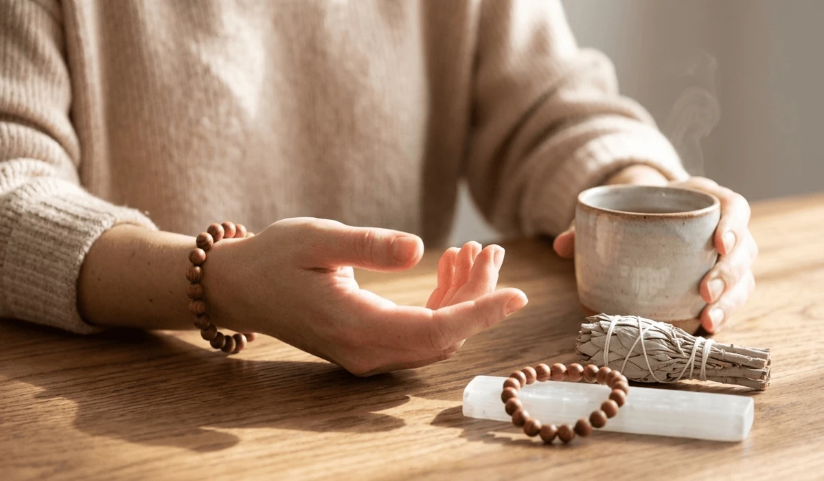 How to wear a rosewood bracelet on the left hand for spiritual receiving, styled with wellness and cleansing tools.