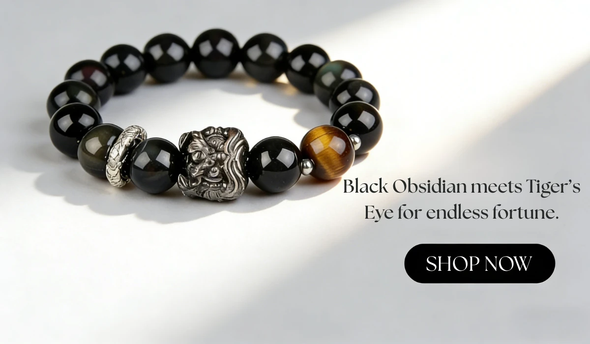 Black beaded bracelet with obsidian, tiger’s eye, a silver dragon charm, and a silver accent ring, paired with text "Black Obsidian meets Tiger’s Eye for endless fortune" and a "SHOP NOW" button.