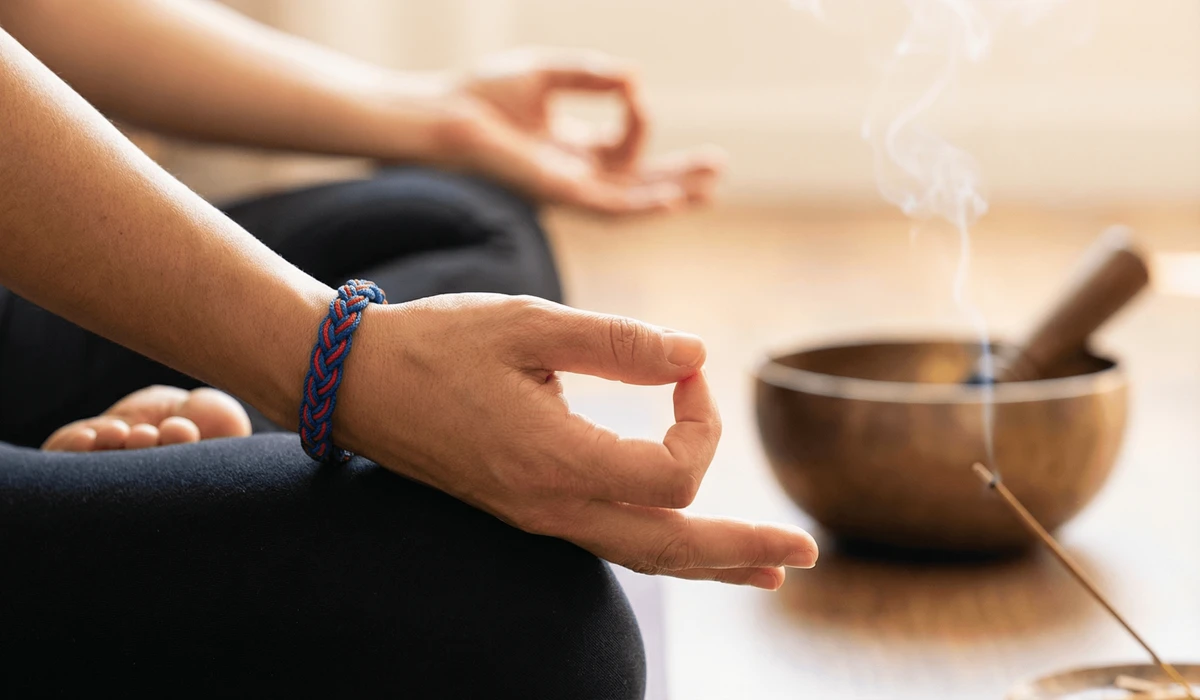 A person wearing a Tibetan bracelet during meditation, representing mindfulness and emotional equilibrium.