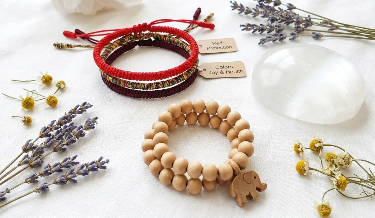 Flat lay of Tibetan red string and natural wood bead bracelets for children, showing different types of spiritual protection jewelry.