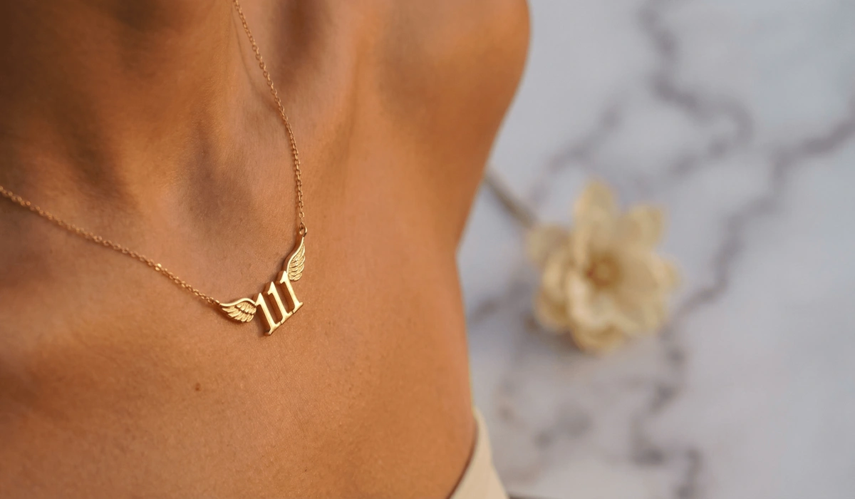 Close-up of a 14k gold 111 angel number necklace representing new beginnings and spiritual connection.