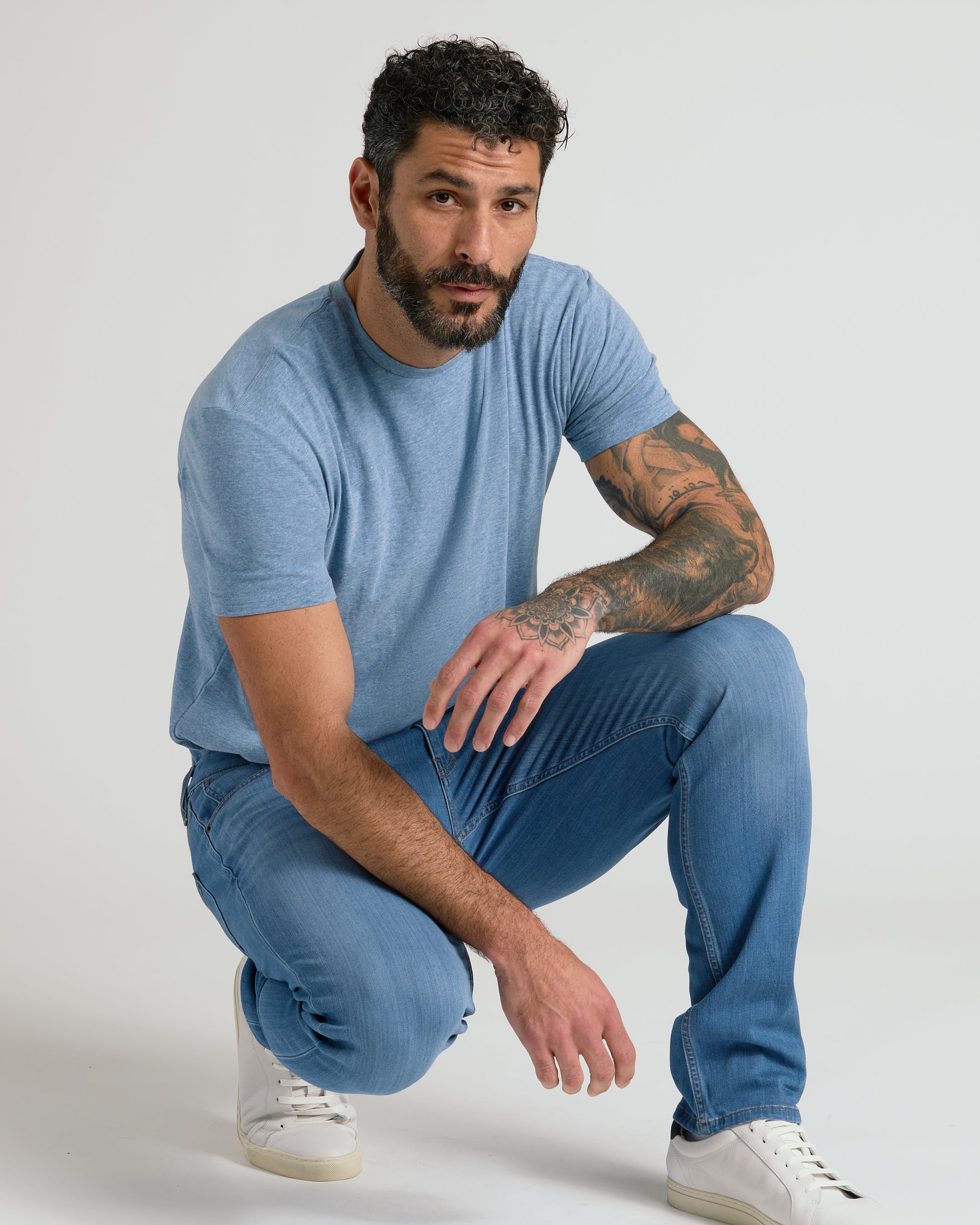 Men's straight fit high-stretch jeans in medium indigo wash - movement fit view