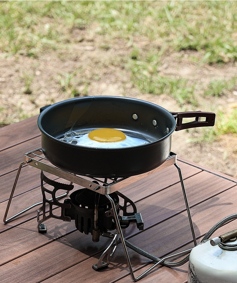 Stainless steel mini pot rack placed on portable grill