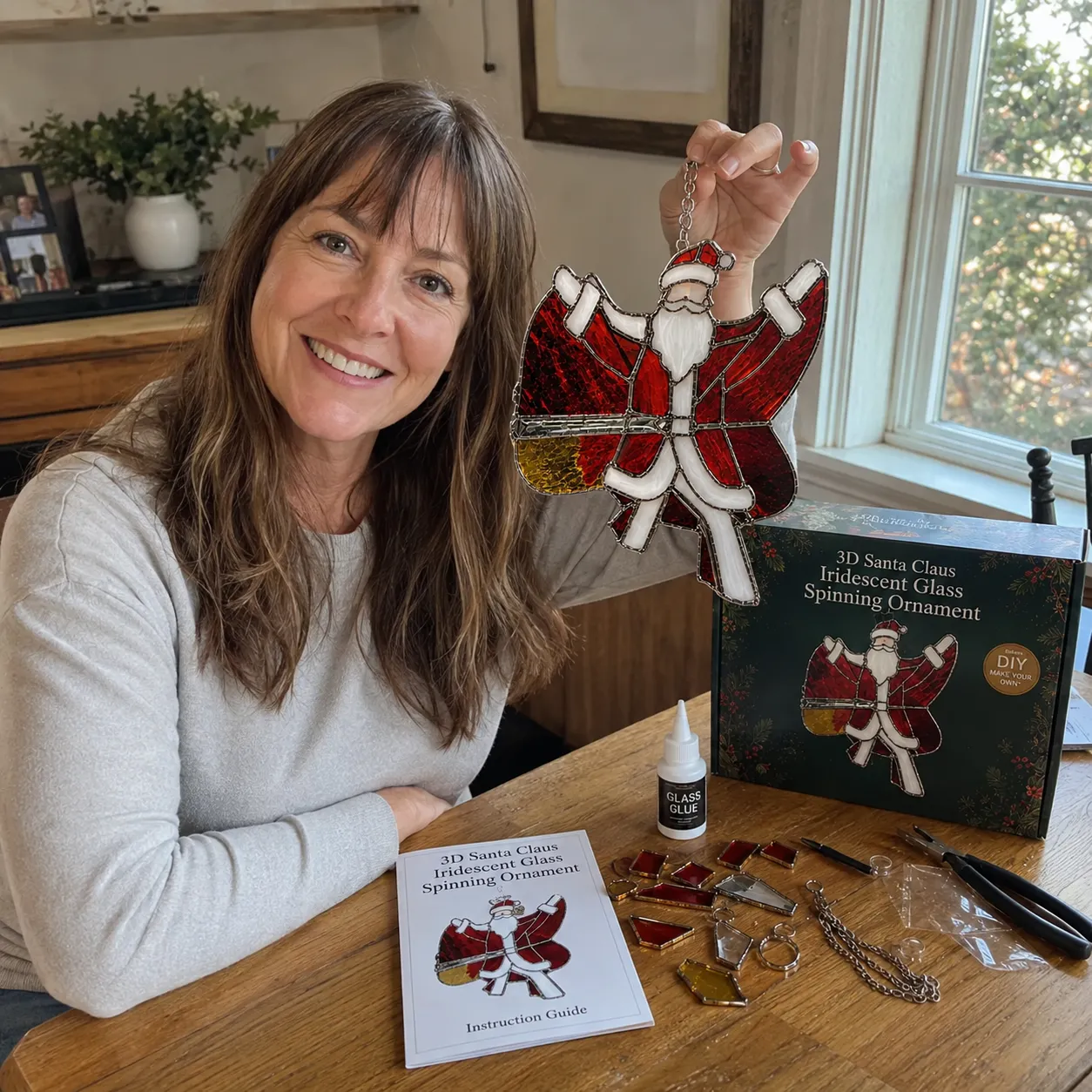 Crafter holding a completed Santa Claus suncatcher