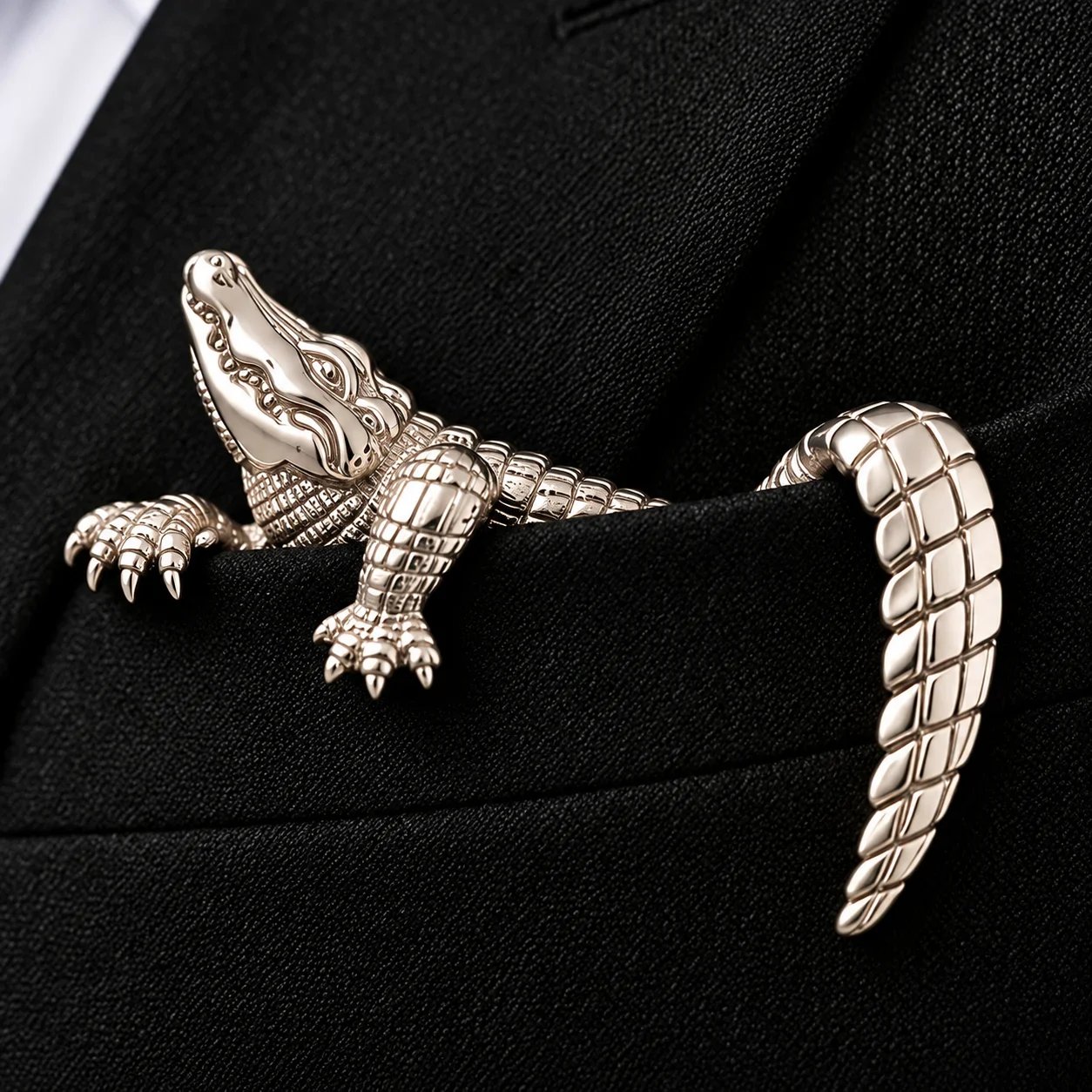 Close view of richly sculpted alligator pocket brooch detail