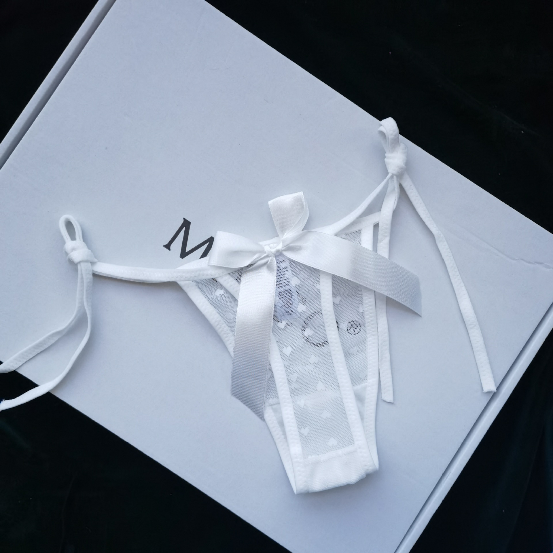 Lace-trimmed, sheer, heart-shaped, sexy thong underwear for women, with ties, in a Japanese anime style