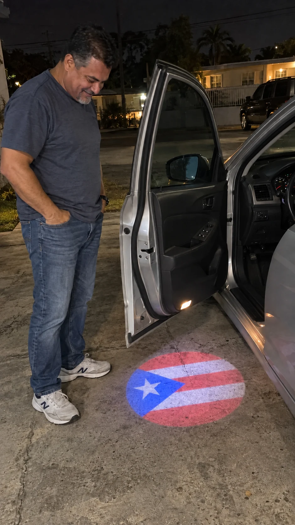 Proud Driver Smiling at Puerto Rican Flag Door Projection at Night