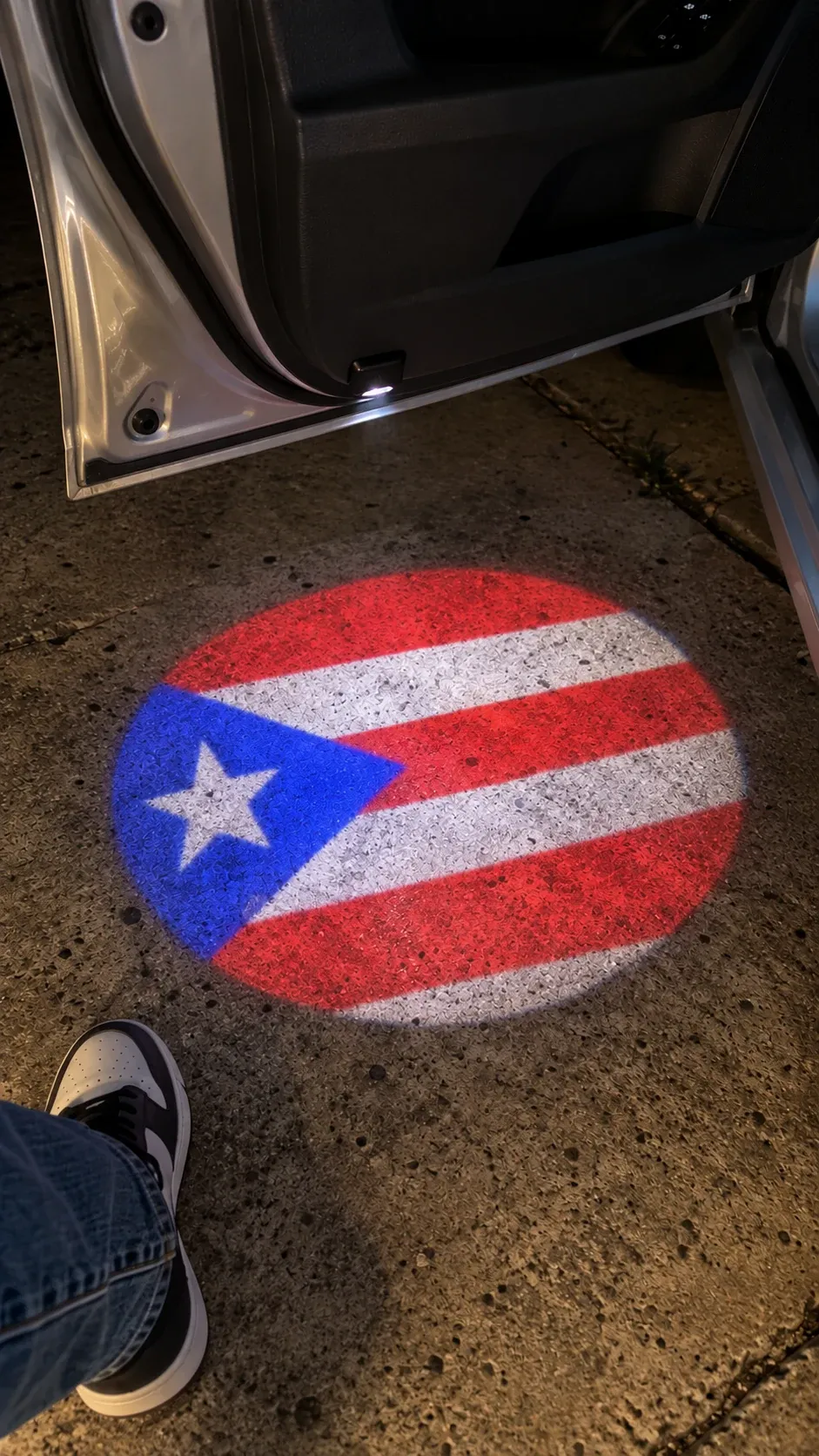 Vibrant Circular Ground Projection Display on Asphalt with Sneaker