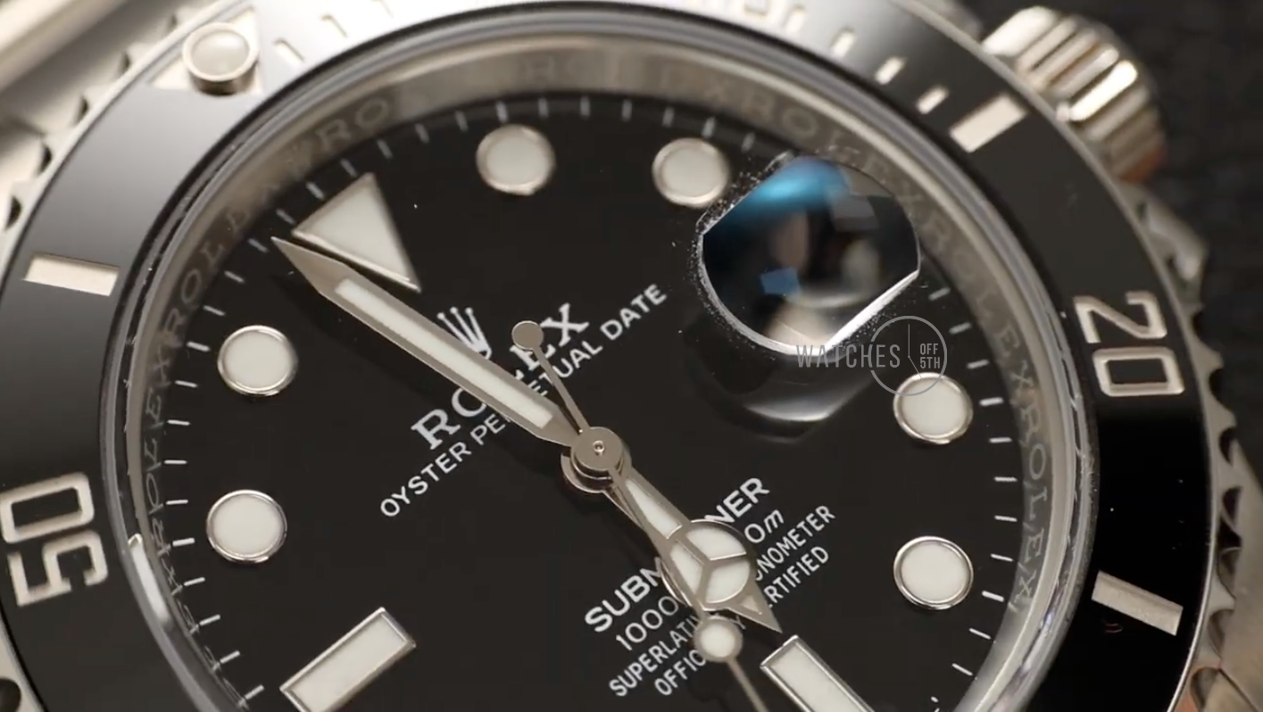 Close-up of the Submariner's black ceramic bezel and dial, highlighting texture and details