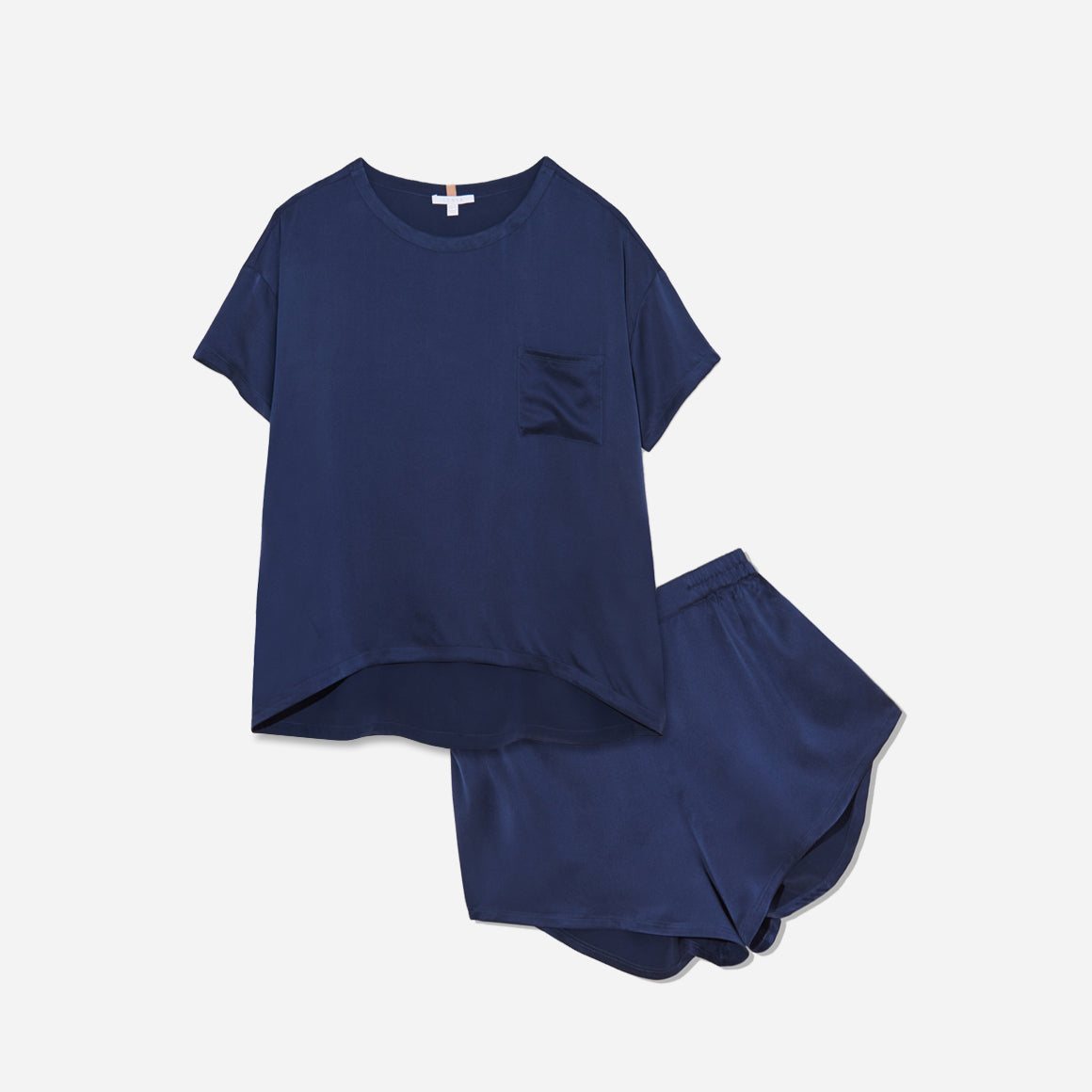 The set includes a short-sleeved tee and relaxed-fit shorts, both crafted from breathable silk fabric that is lightweight, comfortable, and machine washable. The shorts feature an elastic waistband for a perfect fit, while the tee is designed with a flattering neckline, chest pocket, and relaxed fit that drapes beautifully on the body.