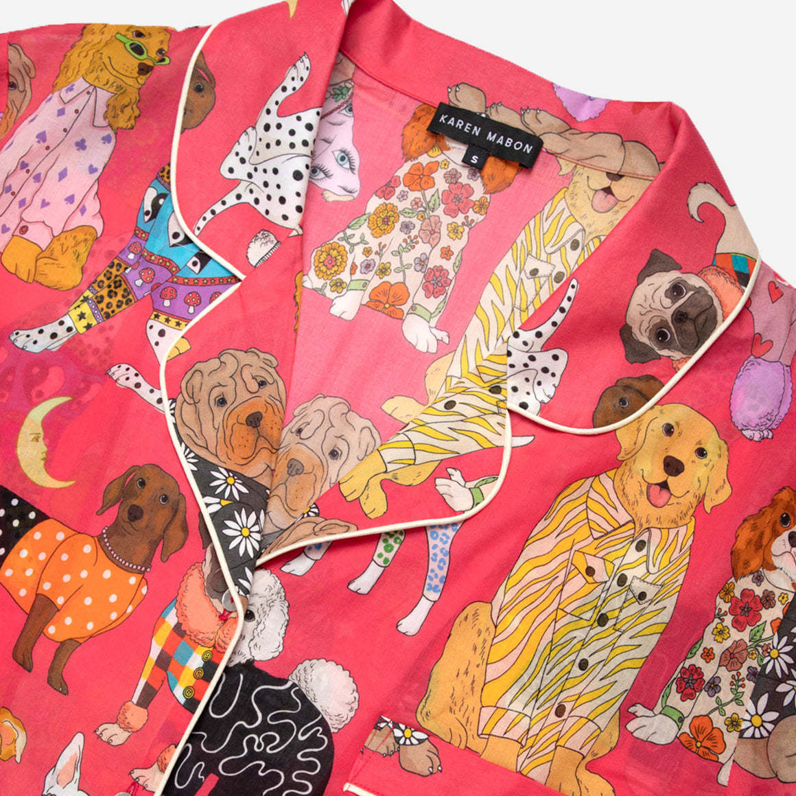 These pajamas feature a tailored fit with short sleeves, making them perfect for warm evenings and mornings spent lounging. The high-quality, soft and breathable cotton fabric feels gentle against your skin and the intricate details and beautiful finishings showcase Karen Mabon’s attention to detail.