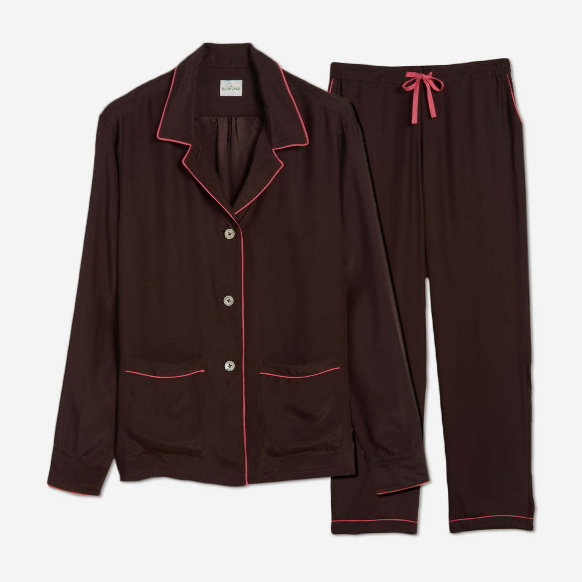 The pajama set includes a classic button-up top with a collar, two patch pockets, and functional button cuffs. The matching pair of pants features a comfortable elastic waistband, drawstring, and side-seam pockets. This cozy pj set is a timeless and stylish look that is perfect for lounging at home.