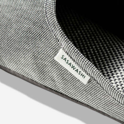 Up-close image of the side of a light grey slipper with Sasawashi written in black on a white tag.