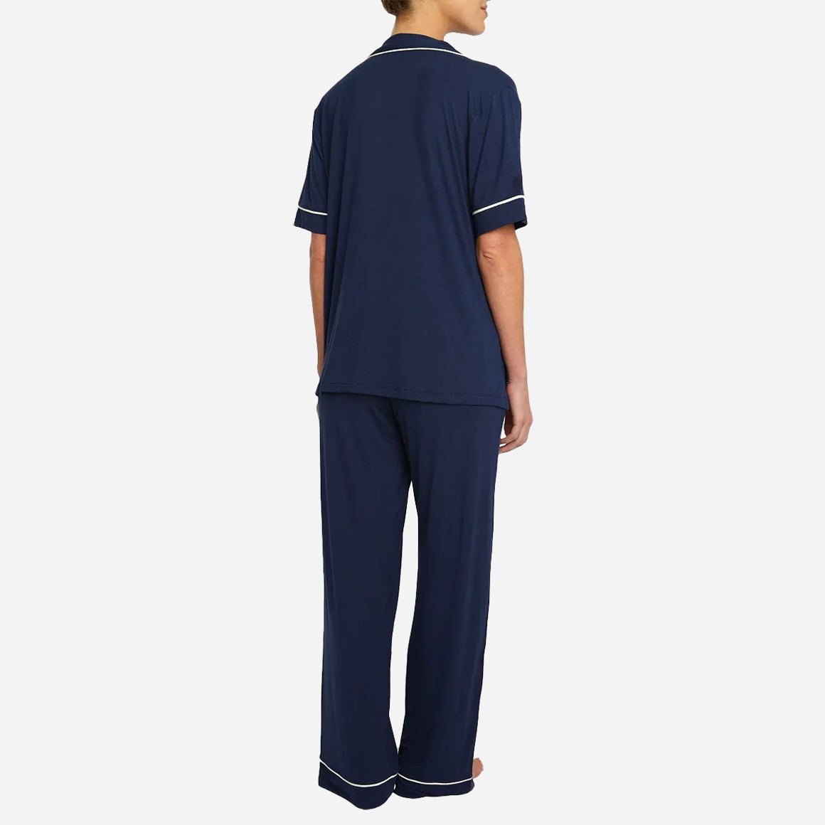 The classic yet contemporary silhouette flatters all body types, and its relaxed fit allows for unrestricted movement and maximum comfort, ensuring you wake up feeling refreshed and rejuvenated. The button-down top exudes sophistication, while the notched collar adds a touch of refinement. The matching low-rise straight leg pants offer a modern and flattering look, while the elastic waistband provides a customized fit.