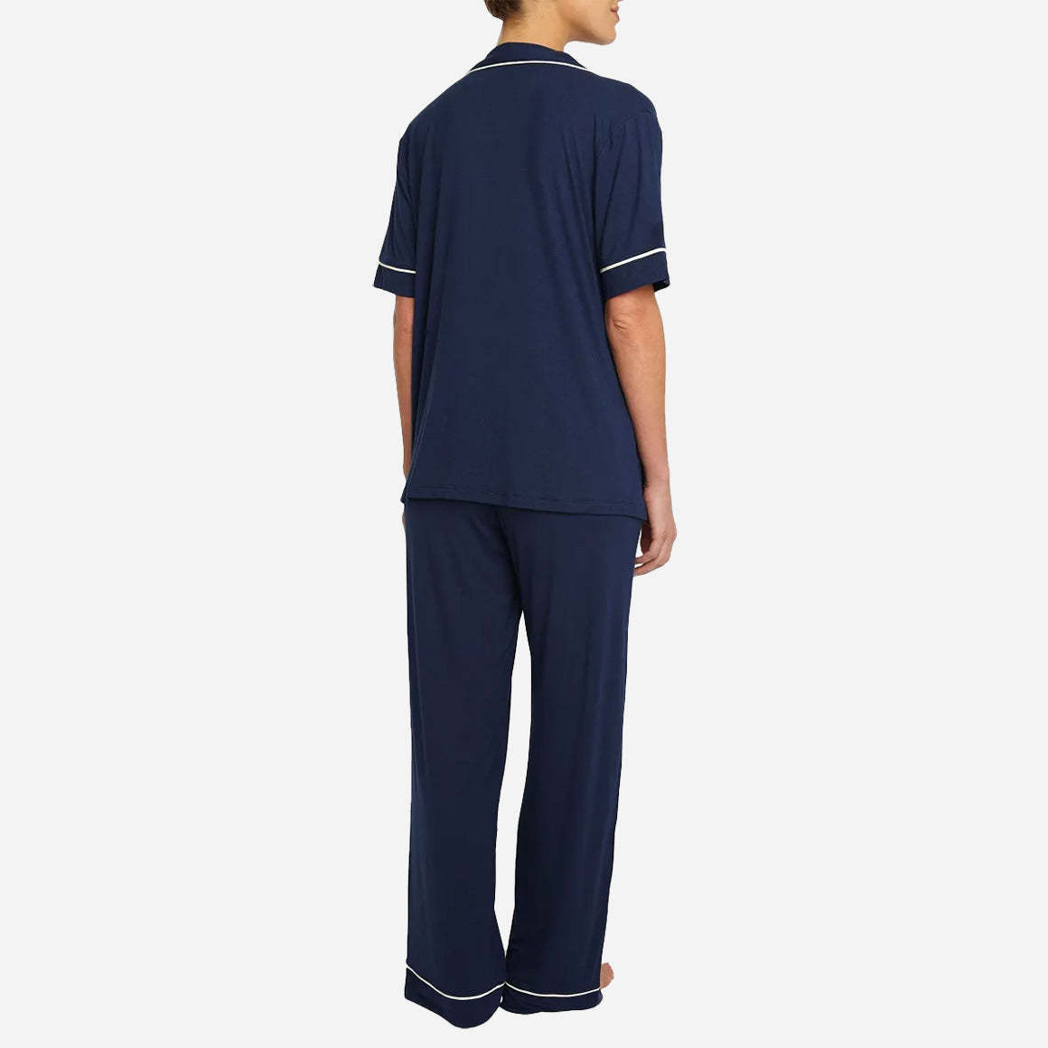 The classic yet contemporary silhouette flatters all body types, and its relaxed fit allows for unrestricted movement and maximum comfort, ensuring you wake up feeling refreshed and rejuvenated. The button-down top exudes sophistication, while the notched collar adds a touch of refinement. The matching low-rise straight leg pants offer a modern and flattering look, while the elastic waistband provides a customized fit.