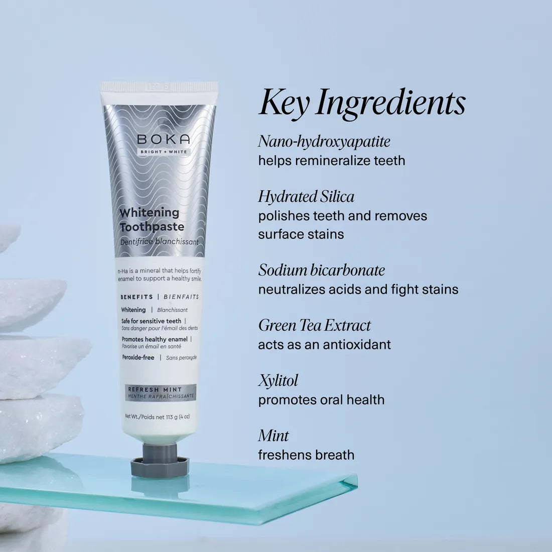 Tube of Refresh Mint Whitening n-Ha Toothpaste for Sensitive Teeth on glass shelf with key ingredients shown.