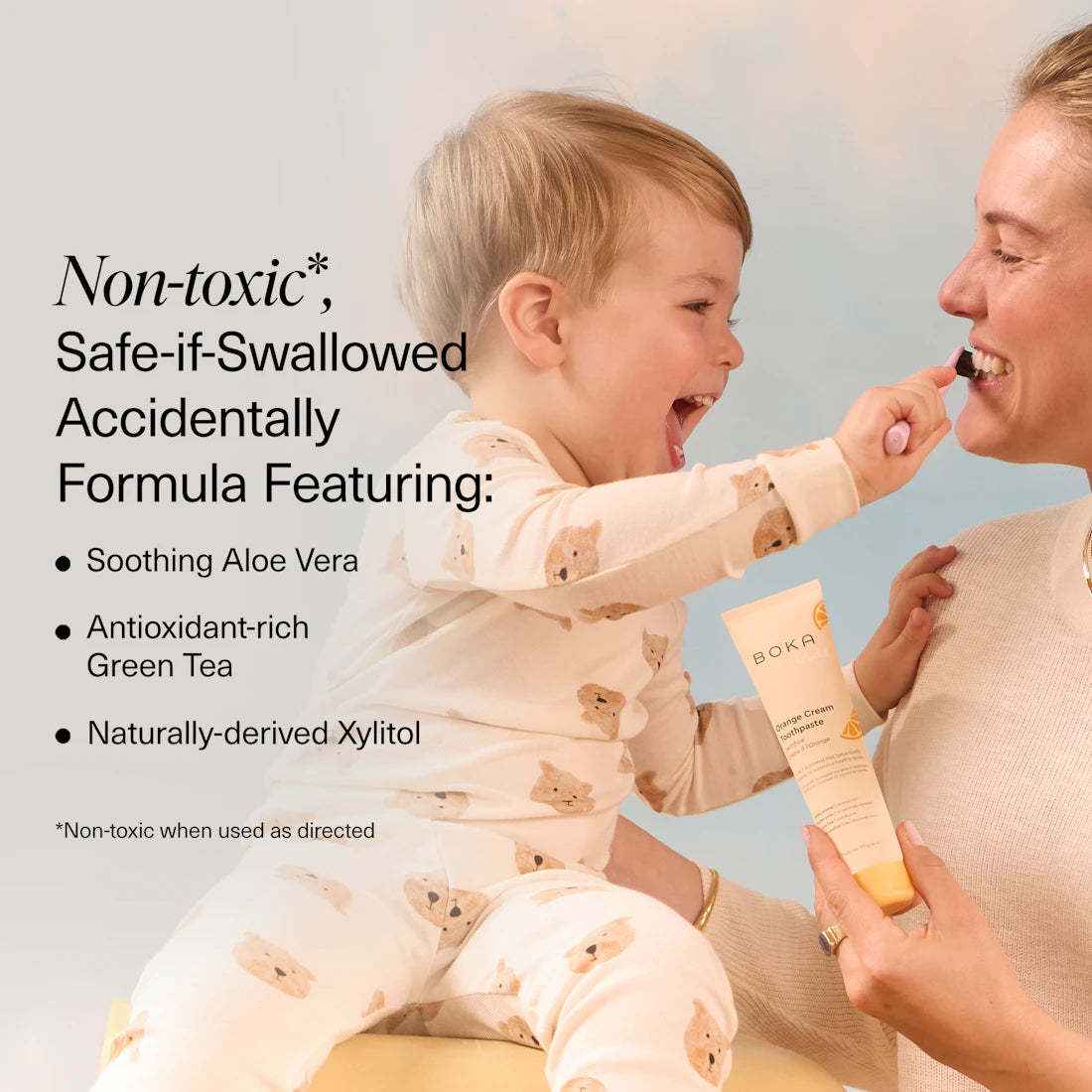 Toddler brushing woman’s teeth with n-Ha Toothpaste Family 3 Pack; features kid-friendly flavors, safe formula.