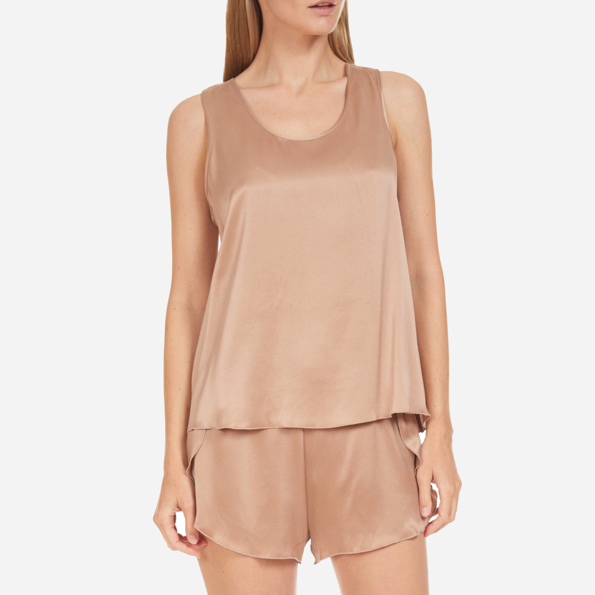The set includes a sleeveless tee and relaxed-fit shorts, both crafted from breathable silk fabric that is lightweight, comfortable, and machine washable. The shorts feature an elastic waistband for a perfect fit, while the top is designed with a flattering neckline and relaxed fit that drapes beautifully on the body.