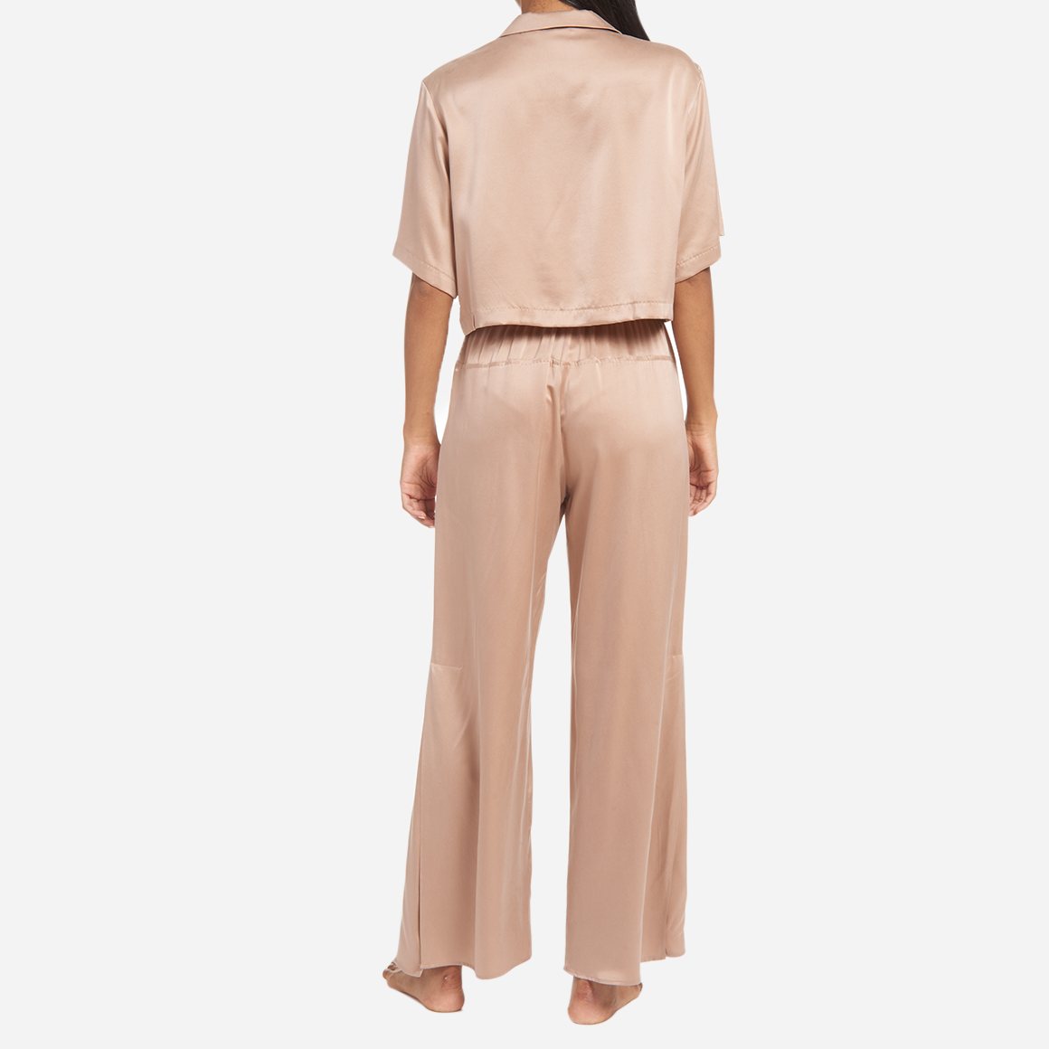 The high-waisted pants have pockets at the hip and side slits at the ankles for added ventilation. The matching short sleeve top is cropped at the waist, has a flattering v-neckline, and chest pocket. The lightweight and breathable fabric makes it perfect for lounging or sleeping, while the elegant design adds a touch of sophistication to your sleepwear collection.