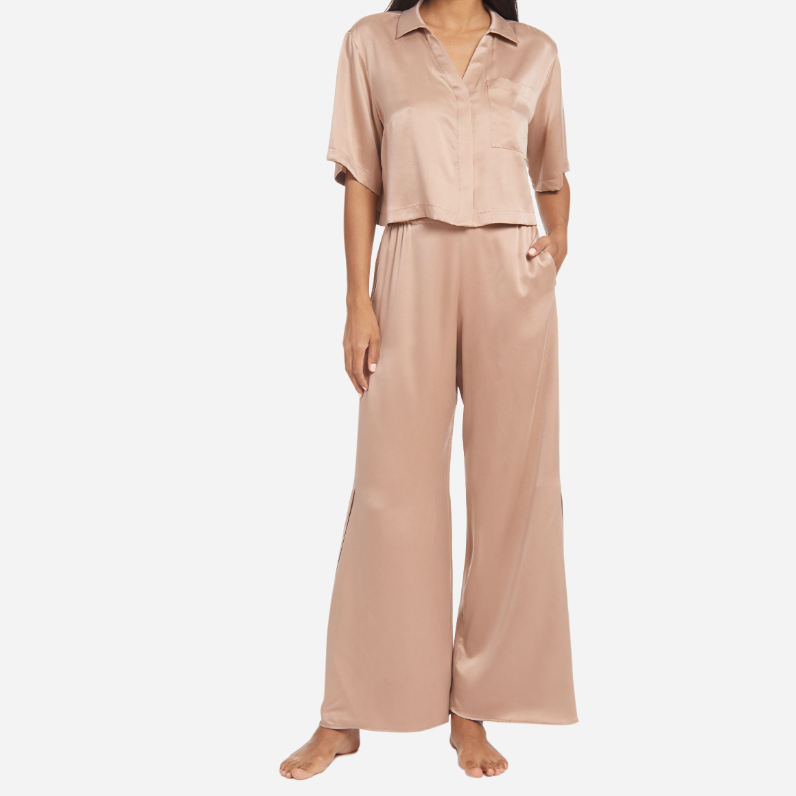 The high-waisted pants have pockets at the hip and side slits at the ankles for added ventilation. The matching short sleeve top is cropped at the waist, has a flattering v-neckline, and chest pocket. The lightweight and breathable fabric makes it perfect for lounging or sleeping, while the elegant design adds a touch of sophistication to your sleepwear collection.