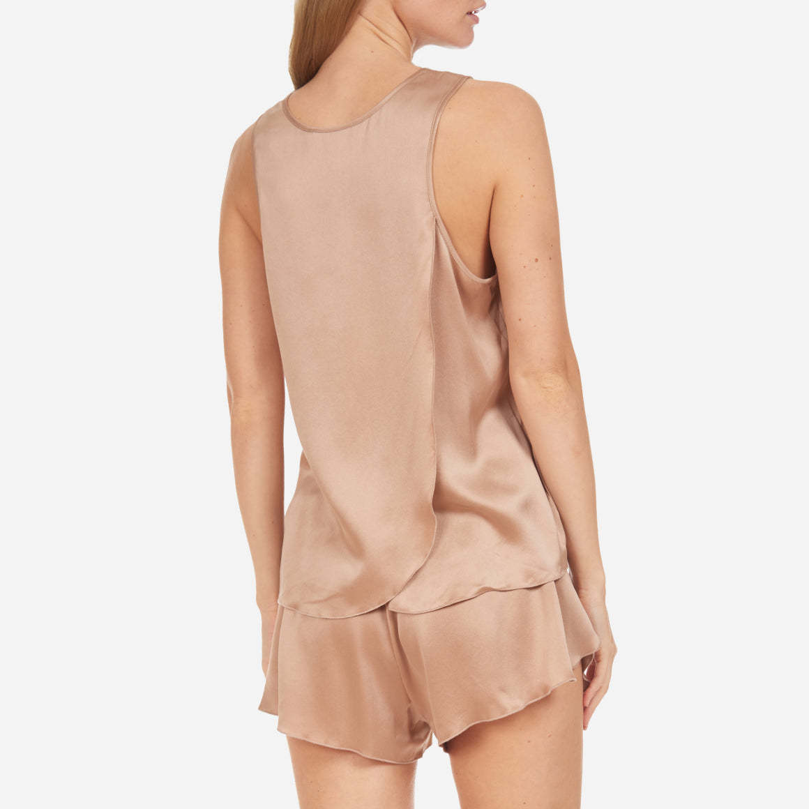 The set includes a sleeveless tee and relaxed-fit shorts, both crafted from breathable silk fabric that is lightweight, comfortable, and machine washable. The shorts feature an elastic waistband for a perfect fit, while the top is designed with a flattering neckline and relaxed fit that drapes beautifully on the body.