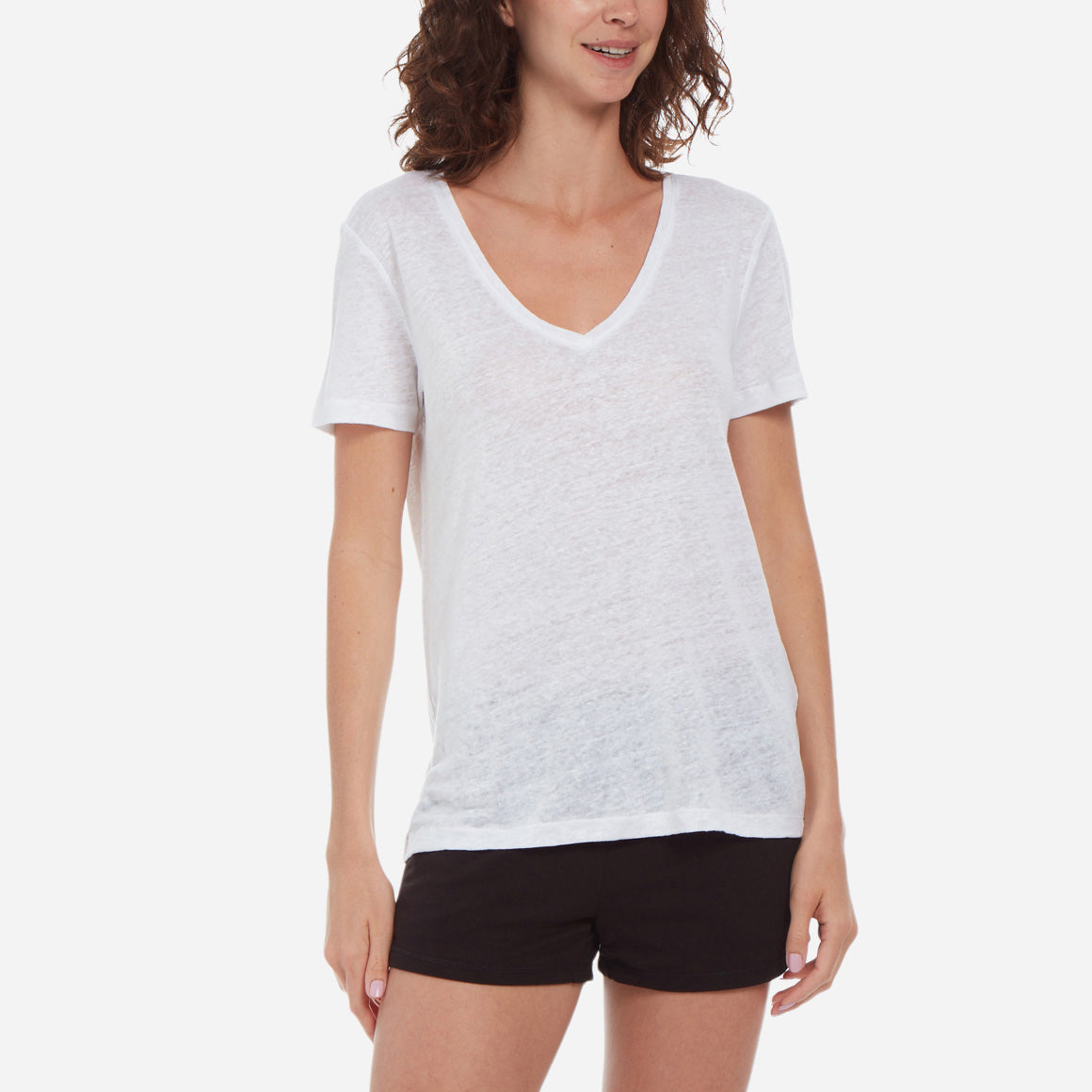 Front-facing model wearing a white linen v-neck tee and black shorts.