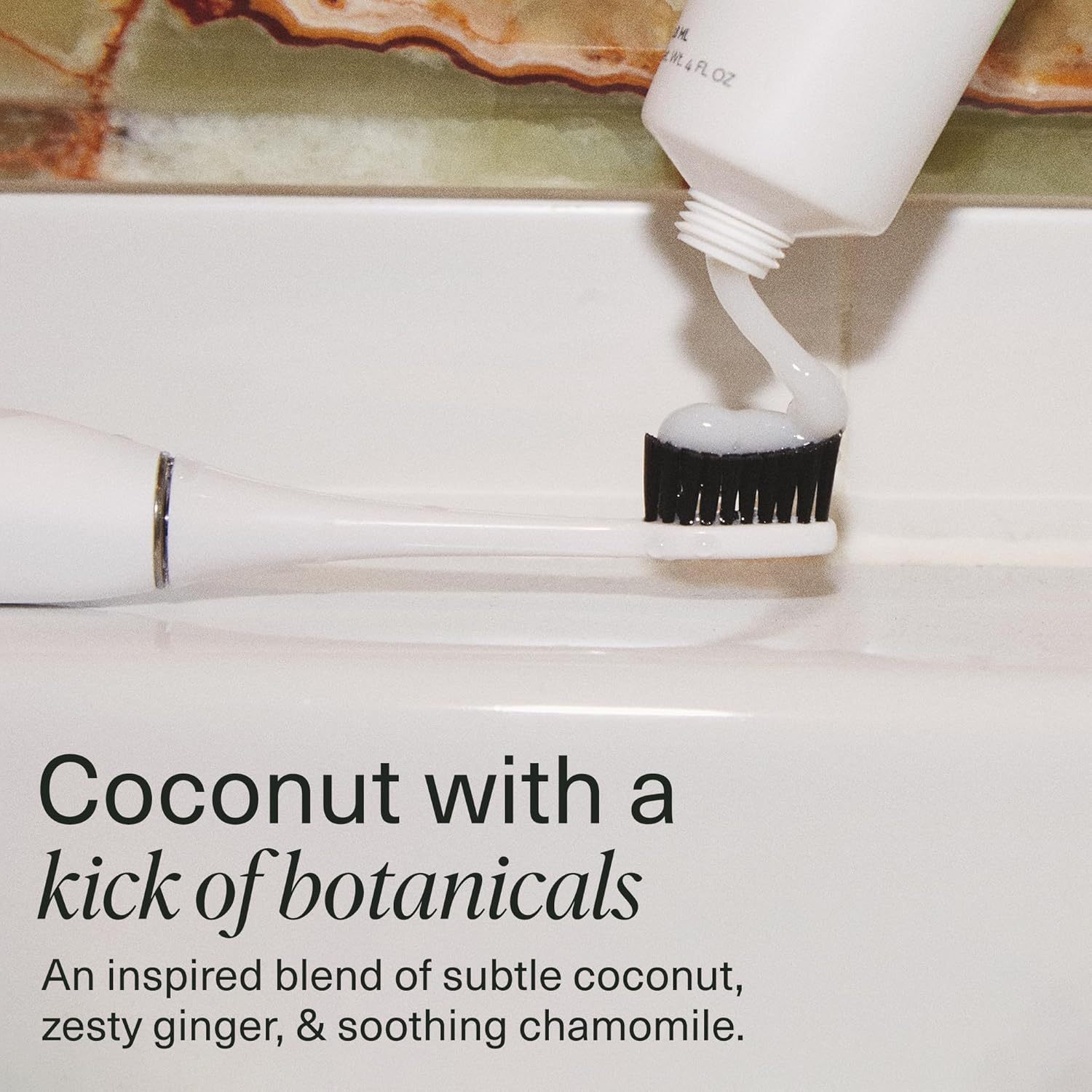 Coco Ginger n-Ha Toothpaste with nano-hydroxyapatite being squeezed onto a toothbrush.