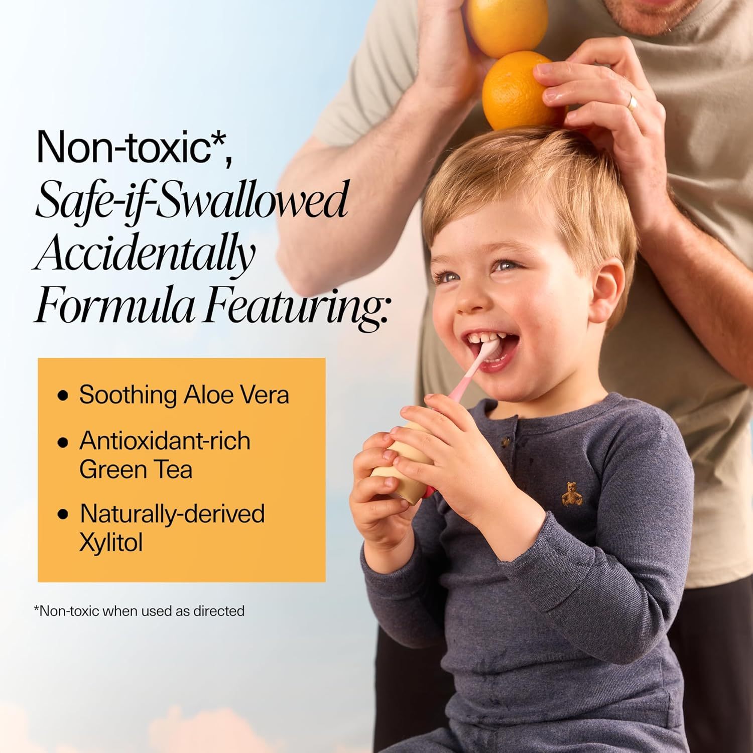 Smiling child enjoys Orange Cream n-Ha Toothpaste as an adult balances oranges on his head.
